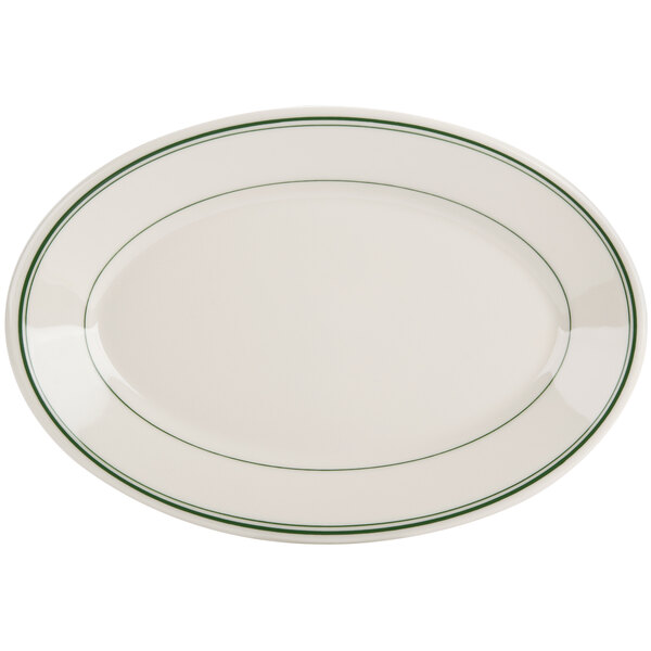 A white oval china platter with a green striped edge.