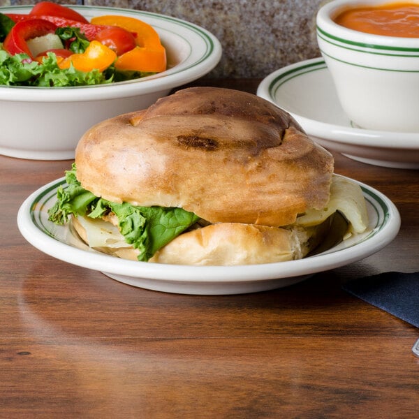 A sandwich and salad on a Homer Laughlin Ivory China plate with a green band.