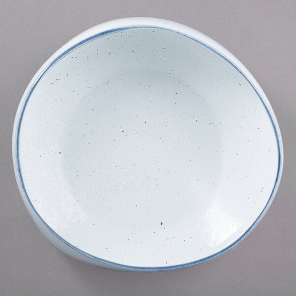 A white porcelain pasta bowl with a blue rim.