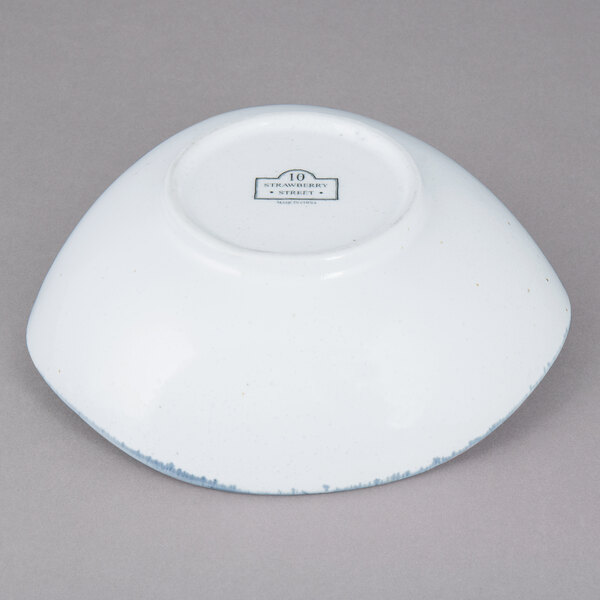 A white bowl with blue specks.