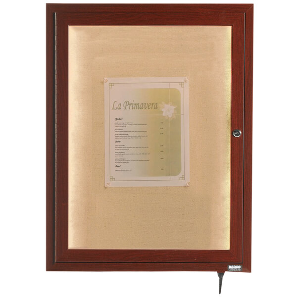 A walnut finished wooden bulletin board cabinet with a lighted menu inside.