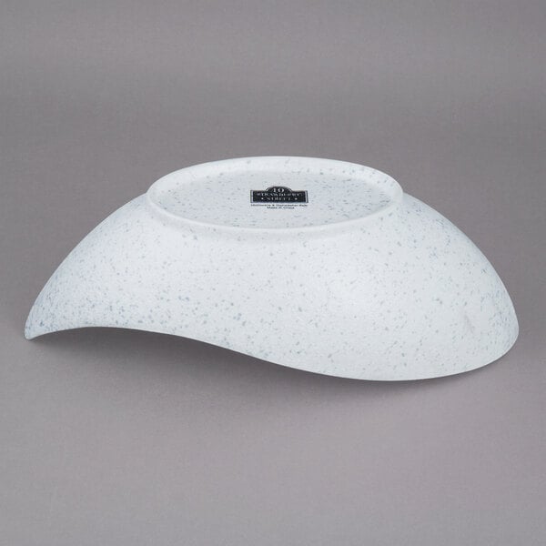 A white porcelain canoe bowl with a blue speckled rim.