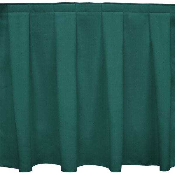 A Caribbean green Snap Drape box pleat table skirt with velcro clips.