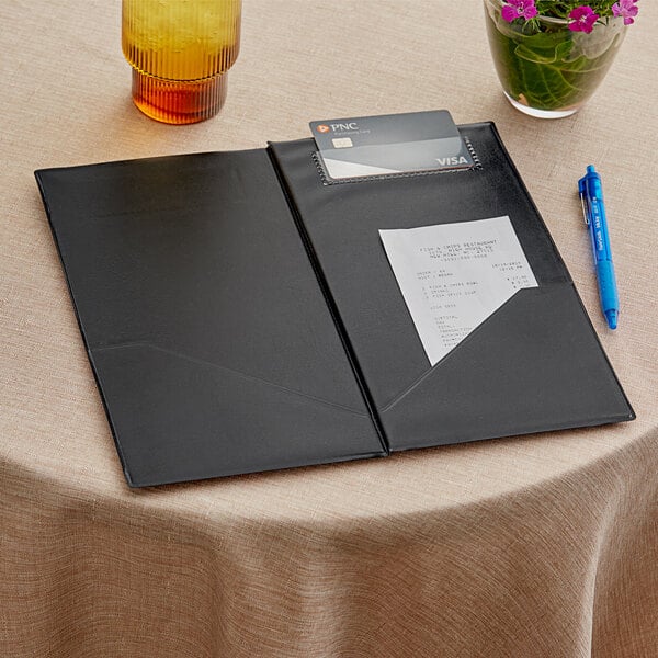 A black Choice guest check presenter holding a credit card and pen.