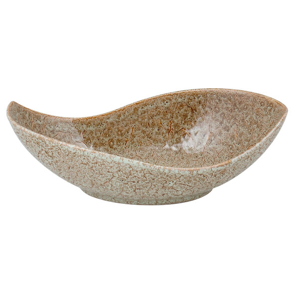 A close-up of a 10 Strawberry Street Tiger Eye porcelain canoe bowl with a brown and white speckled surface.