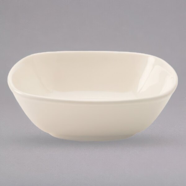 A white bowl with a small rim on a gray background.