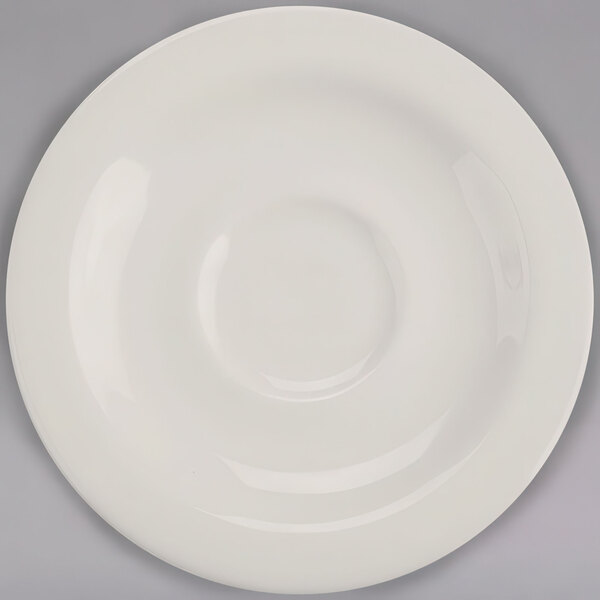 A Homer Laughlin ivory china saucer with a circle in the middle.