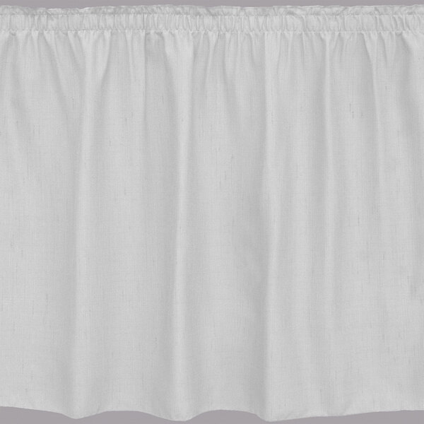 A white table skirt with shirred pleats on the edges.