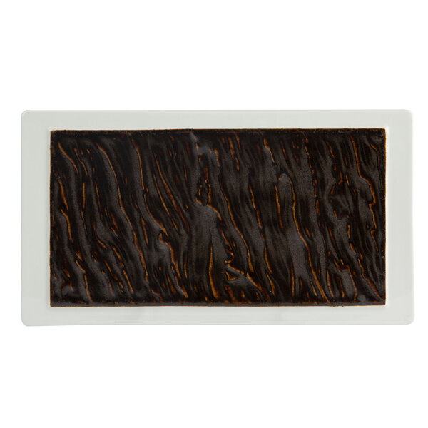 A Tuxton rectangular plate with a white background and black and brown pattern.