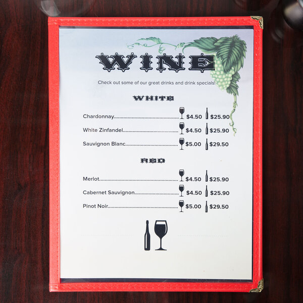 Menu paper with a grapevine and wine glass design on a table.