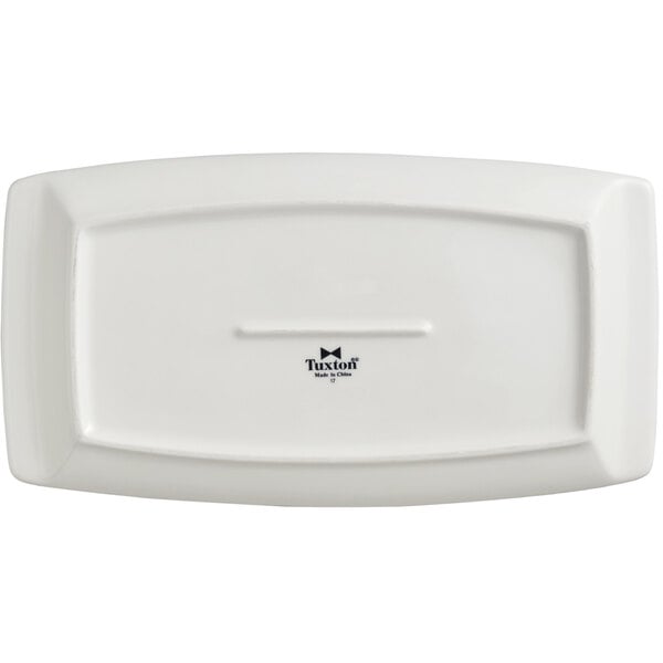 A white rectangular Tuxton China plate with a black logo.