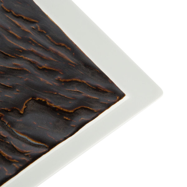 A white Tuxton rectangular plate with a brown pattern.