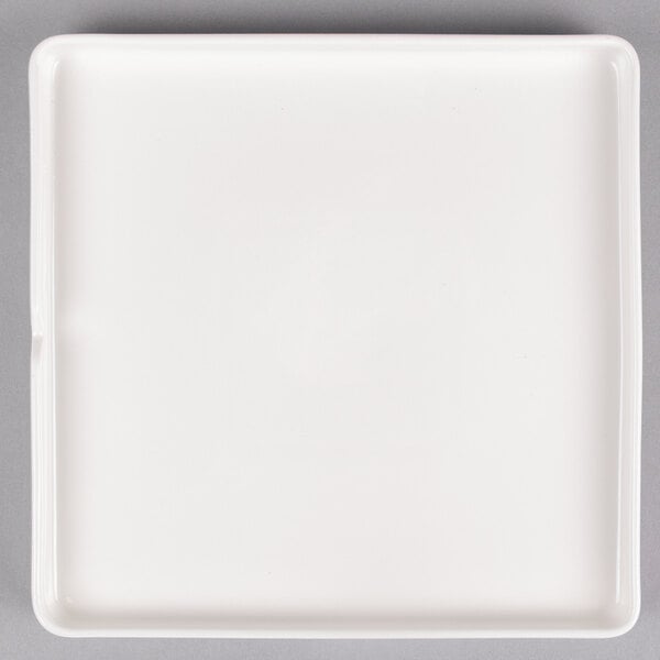 An Arcoroc white porcelain square plate.