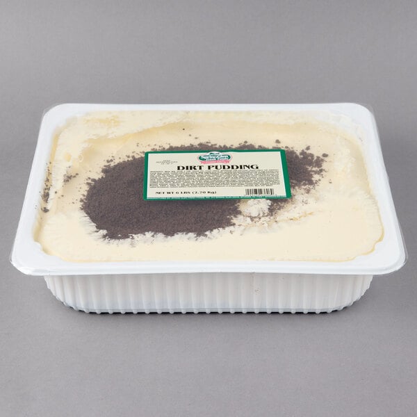 A white and brown pudding in a plastic container with Spring Glen Fresh Foods Dirt Pudding on the label.