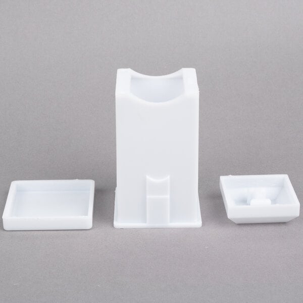 A white plastic container with a white rectangular object with a white circle on the top.