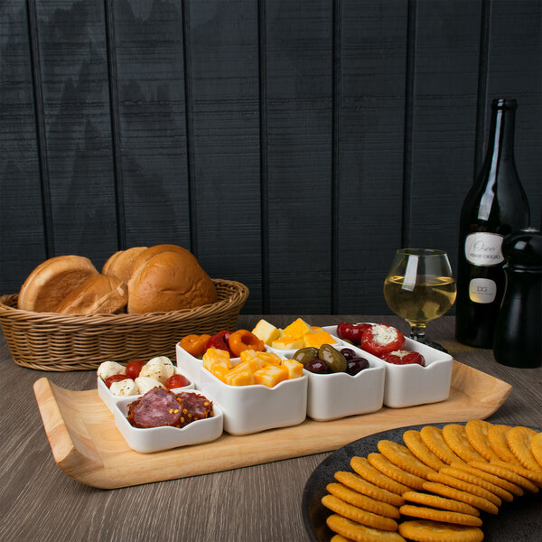 A white bowl with food on a wooden tray.