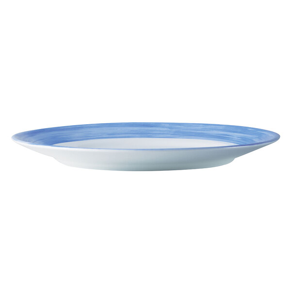 An Arcoroc blue and white opal glass lunch plate with a rim.