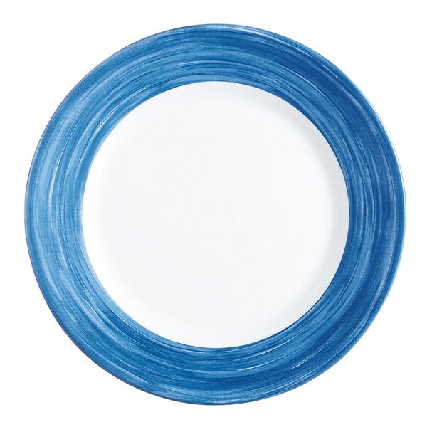 An Arcoroc blue glass dinner plate with a white rim.