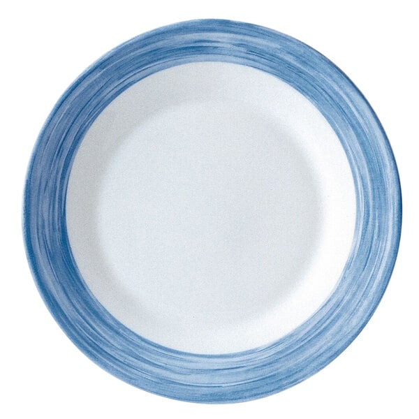 A close-up of a Arcoroc blue and white striped soup plate.