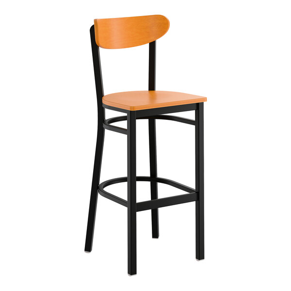 A bar stool with a black metal frame and cherry wood seat and backrest.