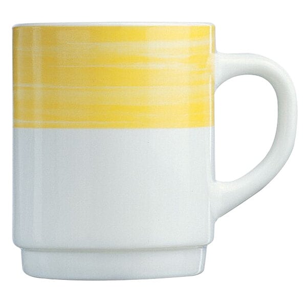 A white coffee mug with a yellow and white striped design and a white handle.