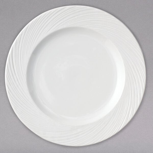 A white porcelain brunch plate with a wavy design on it.