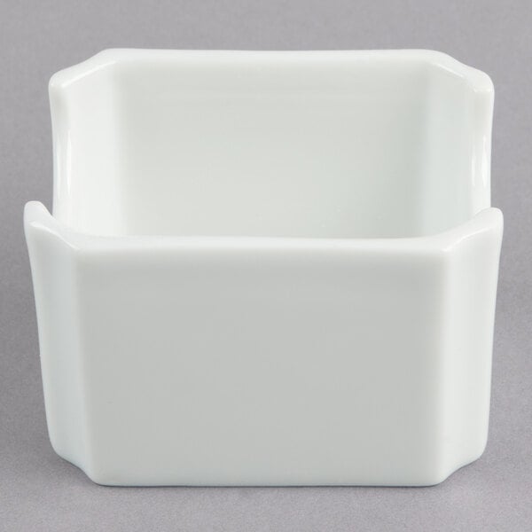 A white square Libbey Reflections porcelain sugar caddy with a curved edge and lid.
