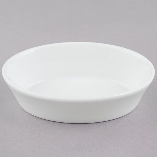 A white oval baker on a grey surface.