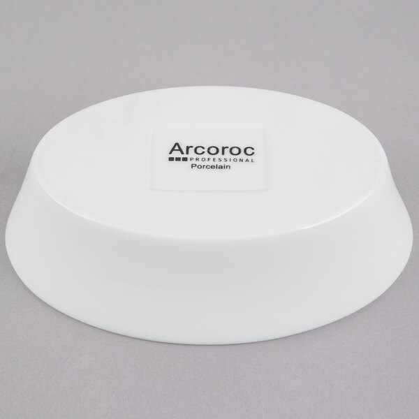 A white oval porcelain baker with black text reading "Arcoroc Capitale" on the bottom.