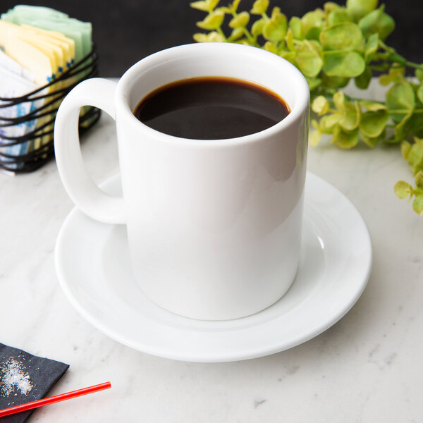 A white saucer with a cup of coffee on it.