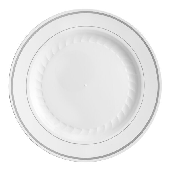 A WNA Comet white plastic plate with a silver rim.