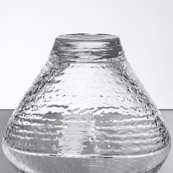 A clear glass bowl with a wavy pattern on the top.