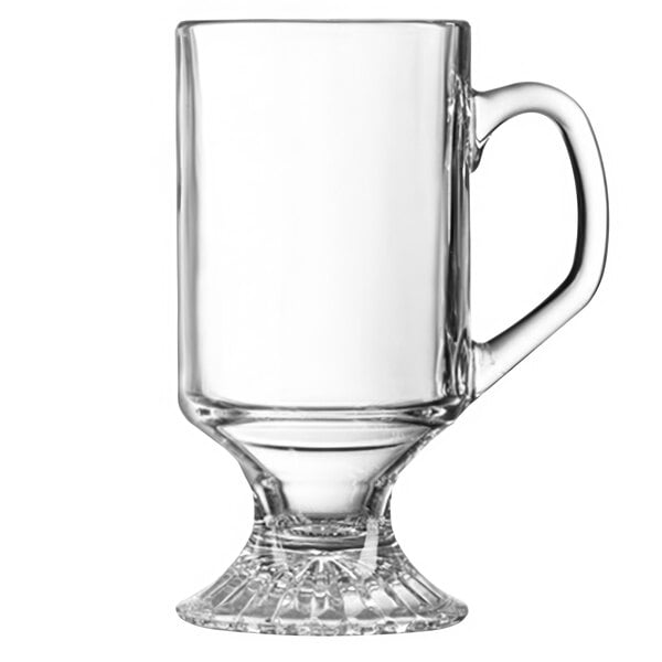 A close-up of a clear glass Arcoroc Irish coffee mug with a handle.