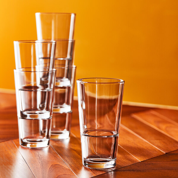 A set of Arcoroc highball glasses on a table.