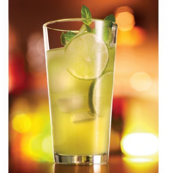 A customizable Arcoroc highball glass filled with lemonade, lime slices, and mint.