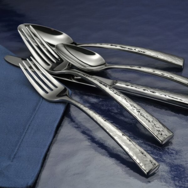 Oneida Cabria stainless steel cold meat fork on a blue surface.