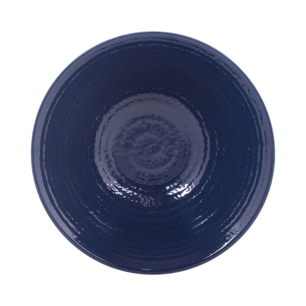 A white melamine bowl with a dark blue rim.