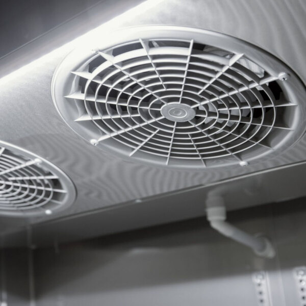 The interior of a Turbo Air M3 Series refrigerator and freezer with two fans.