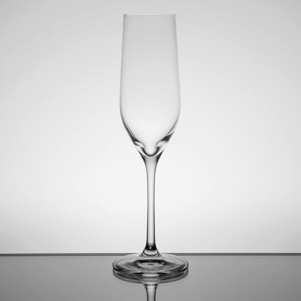 A Stolzle Grand Cuvée flute wine glass on a reflective surface.
