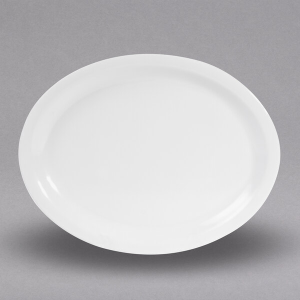 A white Elite Global Solutions oval melamine plate on a gray surface.