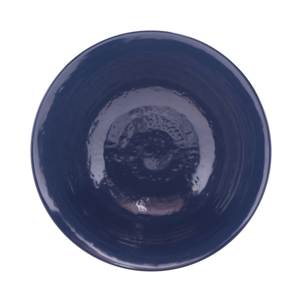 A white melamine bowl with a dark blue rim.