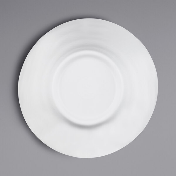 A close-up of an Elite Global Solutions white melamine bowl with a white rim on a gray surface.