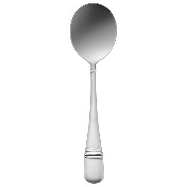 A silver spoon with a round bowl and a white handle.