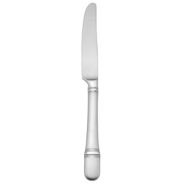 A silver Oneida table knife with a curved edge.