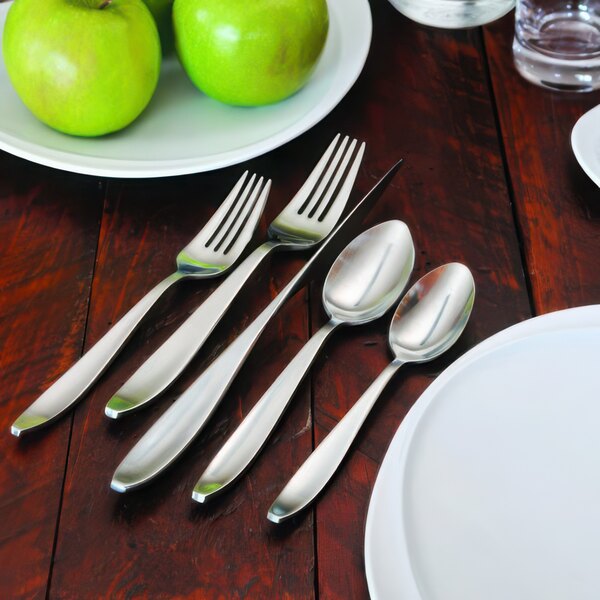 Oneida Sestina stainless steel oval bowl soup/dessert spoons on a table with a plate of green apples.