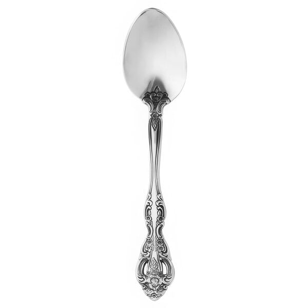 A close-up of an Oneida Michelangelo silver teaspoon with a design on it.