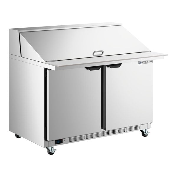 A stainless steel two-door refrigerated sandwich prep table with a raised mega top and ADA height design.