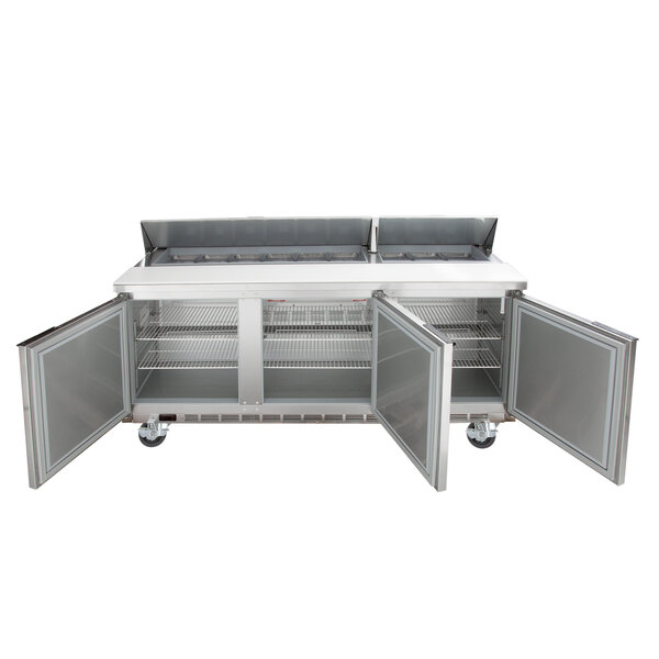A Beverage-Air refrigerated sandwich prep table with two open doors on a stainless steel counter.