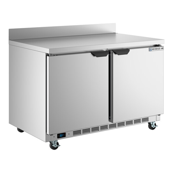 A stainless steel two-door ADA-height worktop refrigerator with a backsplash and casters.