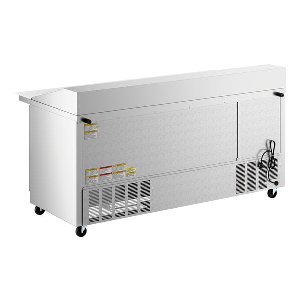 A large stainless steel refrigerated sandwich prep table with three doors, caster wheels, and a rear ventilation system.